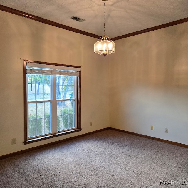 spare room with carpet floors, a chandelier, a textured ceiling, and ornamental molding