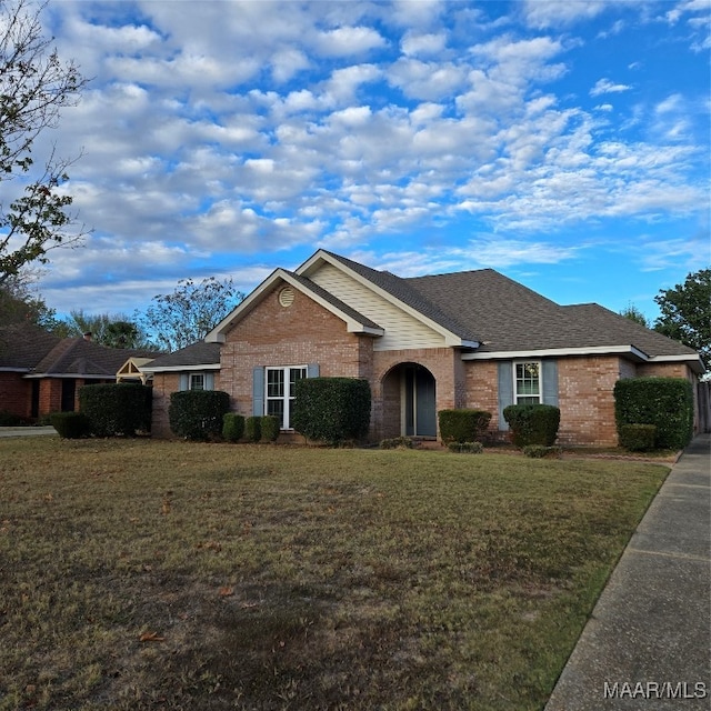 ranch-style home featuring a front yard