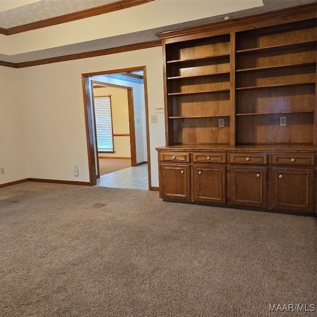 unfurnished living room featuring light carpet and crown molding