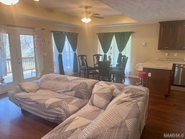 bedroom with access to exterior, french doors, ceiling fan, and dark wood-type flooring