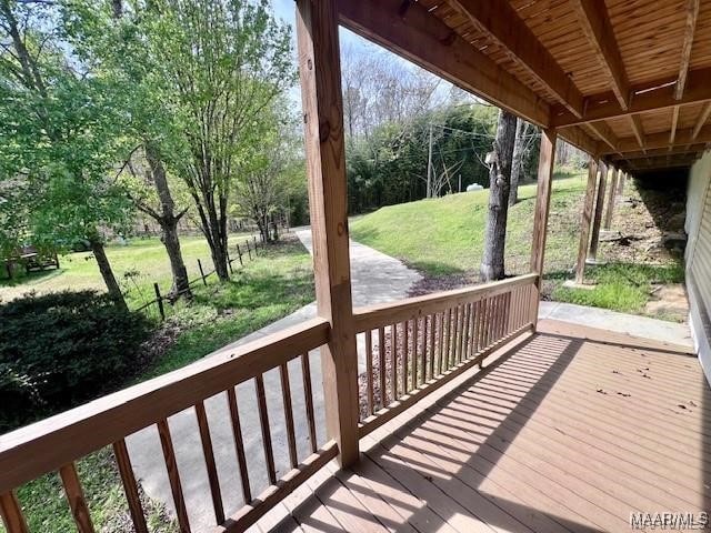 wooden deck featuring a yard