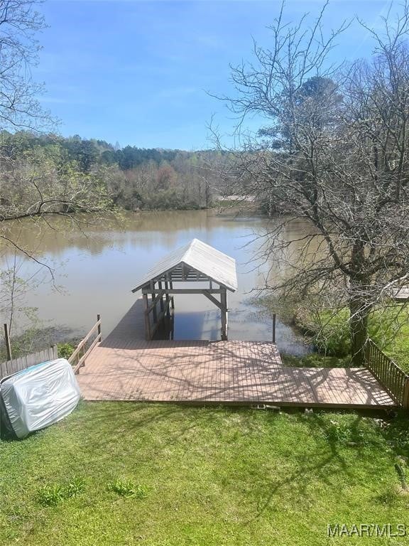 dock area featuring a lawn and a water view