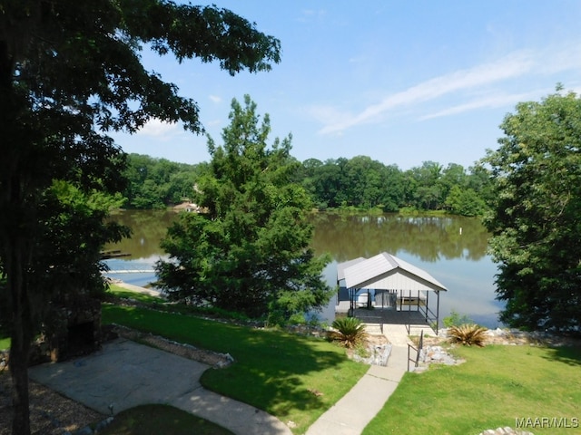 dock area featuring a lawn and a water view