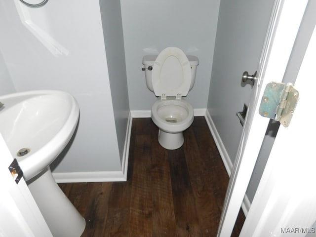 bathroom featuring wood-type flooring and toilet