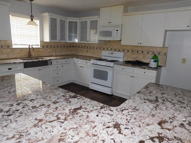 kitchen featuring white cabinets, white appliances, hanging light fixtures, and sink