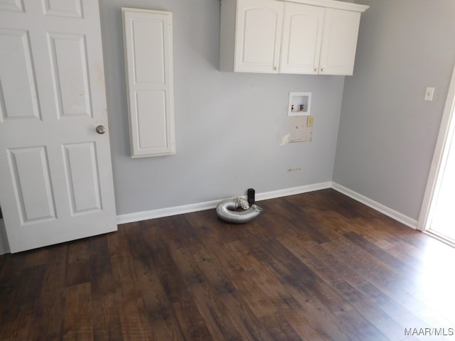 washroom featuring washer hookup, dark hardwood / wood-style flooring, and cabinets