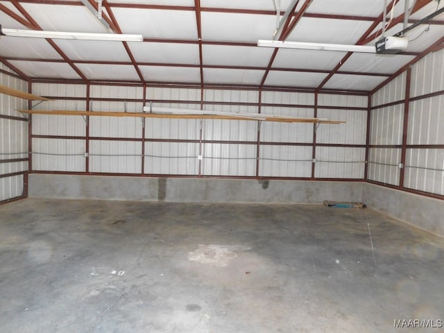 garage featuring a garage door opener and a carport