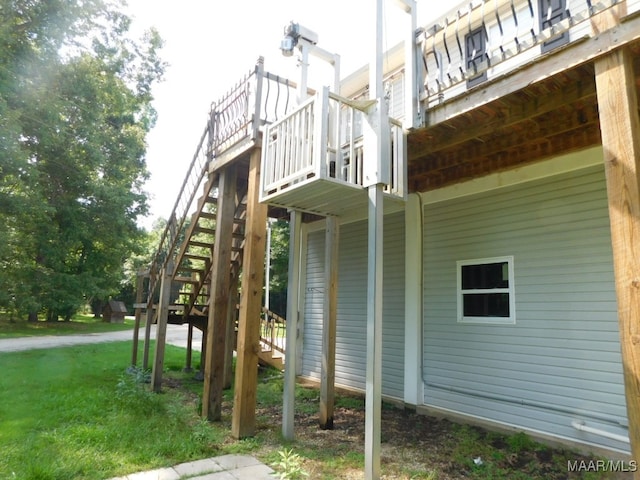 view of side of property featuring a deck and a lawn