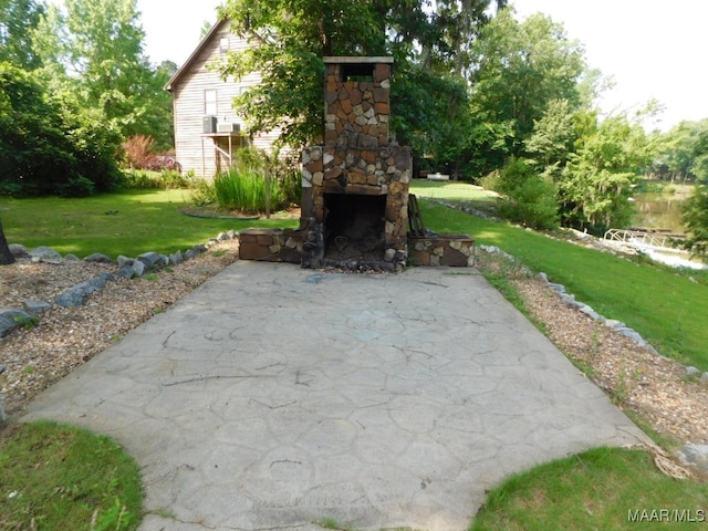 view of patio / terrace featuring an outdoor stone fireplace