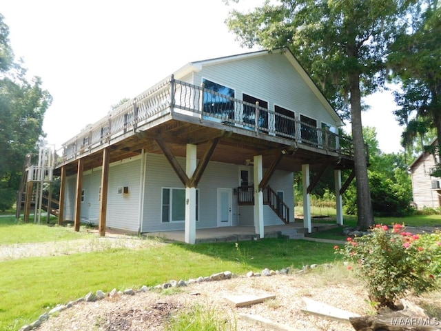 back of property with a yard and a wooden deck