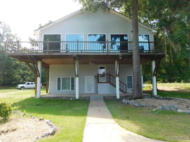 view of front facade featuring a front yard and a wooden deck