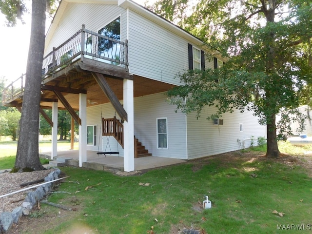 back of house featuring a yard, a patio area, and a wooden deck