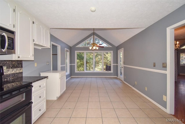 171 Griffith Ln, Tallassee, AL 36078 - kitchen featuring range with two ovens, stainless steel microwave, a ceiling fan, white cabinets, and a textured ceiling