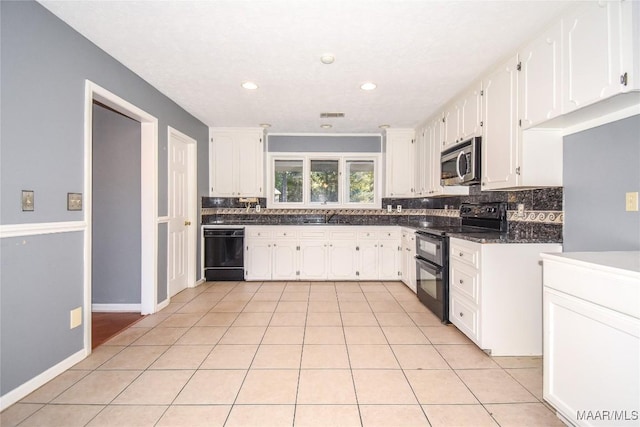 171 Griffith Ln, Tallassee, AL 36078 - kitchen with black appliances, dark countertops, tasteful backsplash, white cabinetry, and a sink