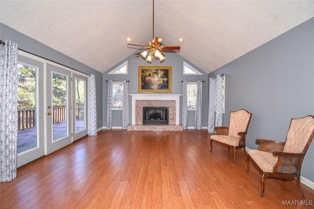 171 Griffith Ln, Tallassee, AL 36078 - unfurnished living room with wood finished floors, a ceiling fan, a fireplace, baseboards, and lofted ceiling