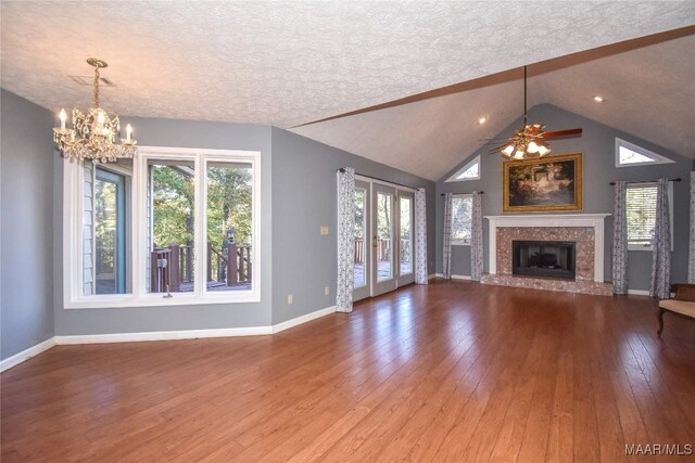 171 Griffith Ln, Tallassee, AL 36078 - unfurnished living room with a textured ceiling, a chandelier, hardwood / wood-style flooring, baseboards, and a premium fireplace