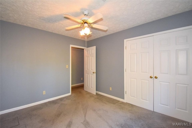 171 Griffith Ln, Tallassee, AL 36078 - unfurnished bedroom with a closet, carpet, baseboards, a textured ceiling, and a ceiling fan
