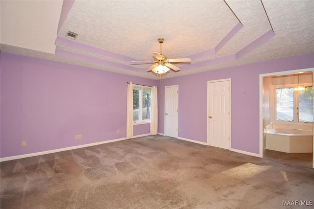171 Griffith Ln, Tallassee, AL 36078 - carpeted spare room featuring a raised ceiling, a textured ceiling, baseboards, and a ceiling fan