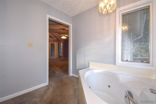 171 Griffith Ln, Tallassee, AL 36078 - full bath featuring a tub with jets, baseboards, and a chandelier