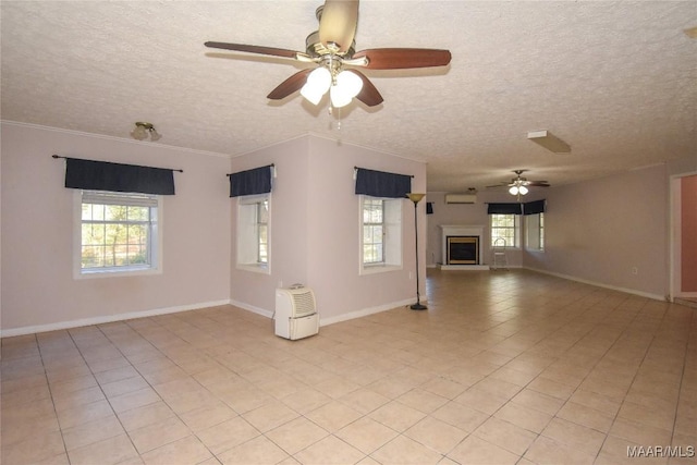171 Griffith Ln, Tallassee, AL 36078 - unfurnished living room with ceiling fan, plenty of natural light, a textured ceiling, and baseboards