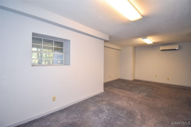 171 Griffith Ln, Tallassee, AL 36078 - below grade area with a wall mounted AC, dark colored carpet, and baseboards