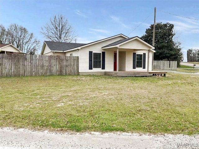 bungalow with fence and a front yard