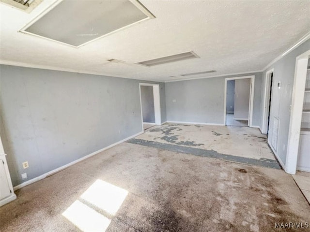 interior space with baseboards, a textured ceiling, and carpet flooring