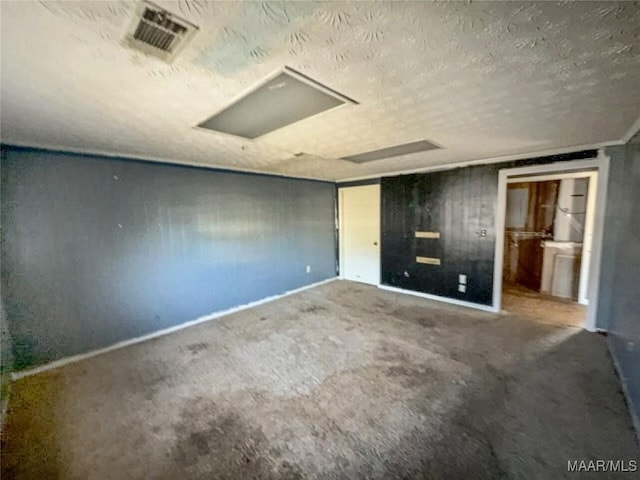 unfurnished bedroom featuring a textured ceiling and visible vents