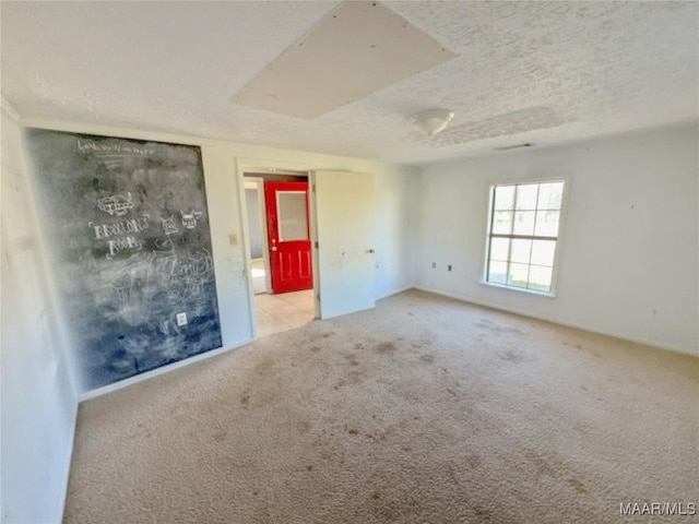 spare room with carpet floors and a textured ceiling