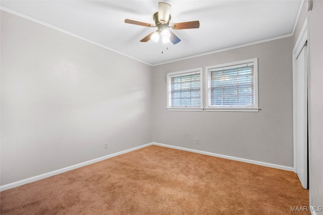 unfurnished room with ceiling fan, crown molding, and light carpet