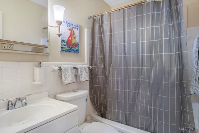 full bathroom featuring shower / tub combo, vanity, toilet, and tile walls