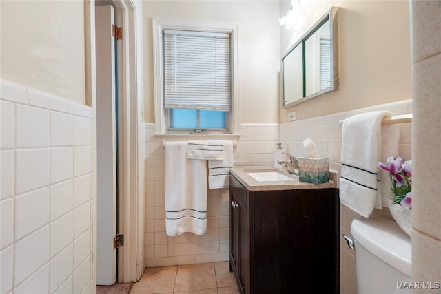 bathroom with vanity, tile patterned floors, and tile walls