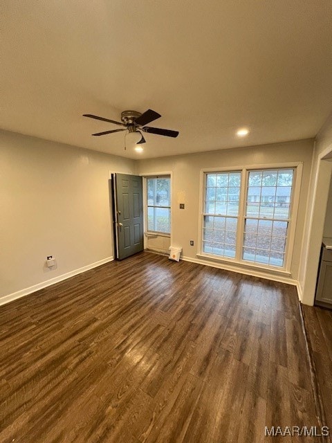 spare room featuring ceiling fan and dark hardwood / wood-style flooring