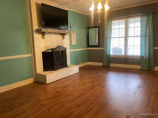 unfurnished living room with a brick fireplace, hardwood / wood-style flooring, ornamental molding, and ceiling fan