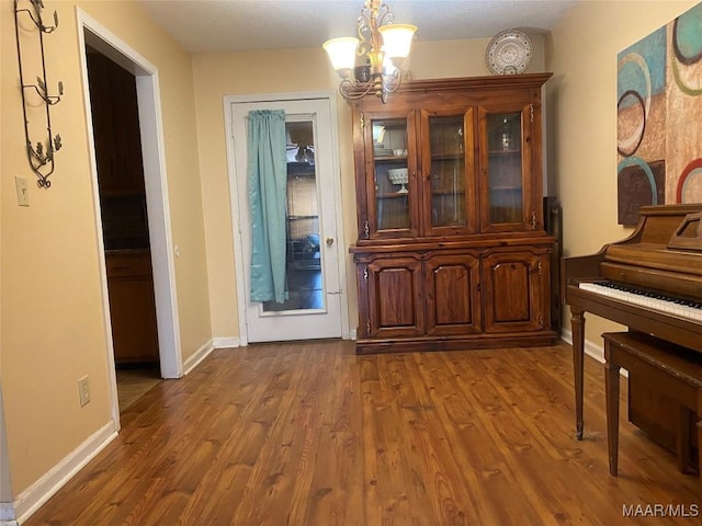 dining room with hardwood / wood-style flooring and a notable chandelier