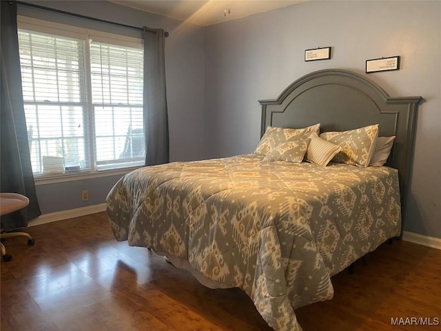 bedroom with dark wood-type flooring