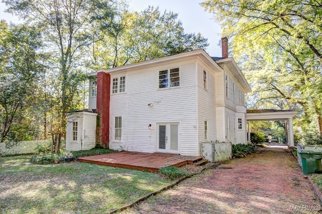 rear view of property featuring french doors and a wooden deck