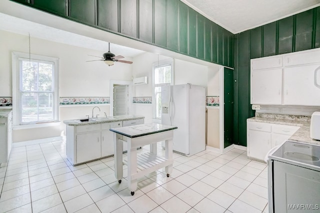 kitchen with ceiling fan, sink, white refrigerator with ice dispenser, white cabinets, and light tile patterned flooring