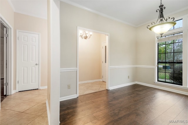 spare room featuring hardwood / wood-style floors and ornamental molding