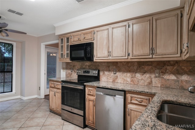 kitchen with crown molding, light stone counters, backsplash, and appliances with stainless steel finishes