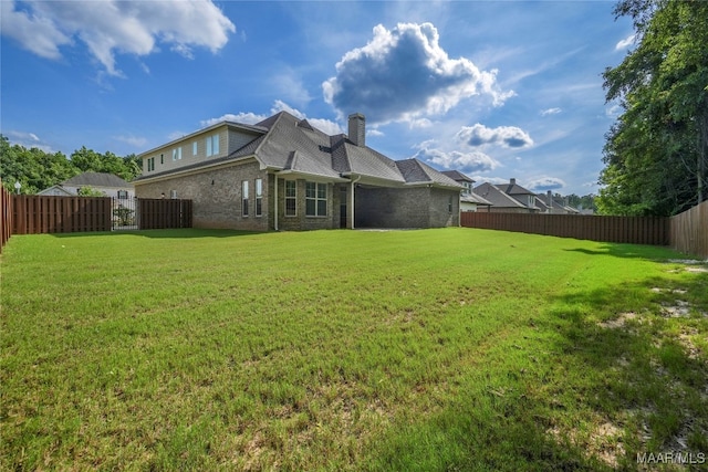 rear view of house featuring a lawn