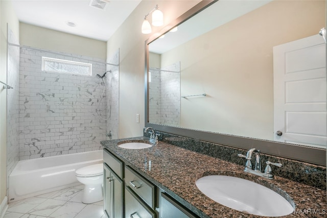 full bathroom with vanity, tiled shower / bath combo, and toilet