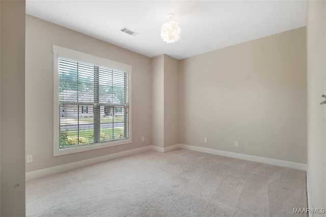 carpeted spare room with a healthy amount of sunlight