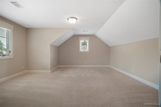 bonus room featuring light colored carpet and lofted ceiling