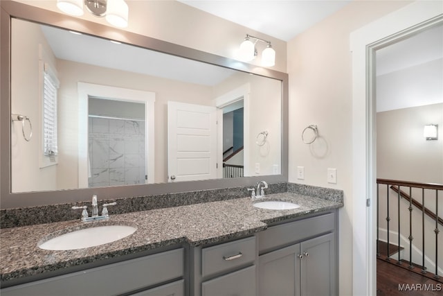 bathroom featuring vanity, wood-type flooring, and walk in shower