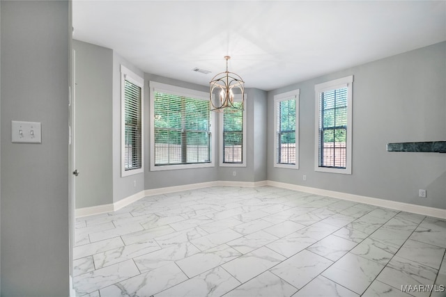 unfurnished room featuring a notable chandelier