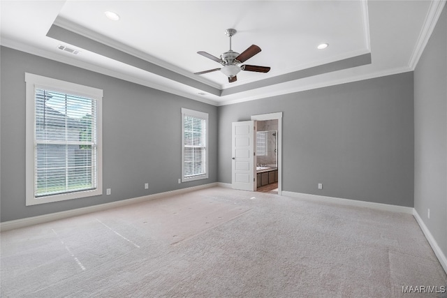 unfurnished bedroom featuring ensuite bathroom, a raised ceiling, ceiling fan, and crown molding