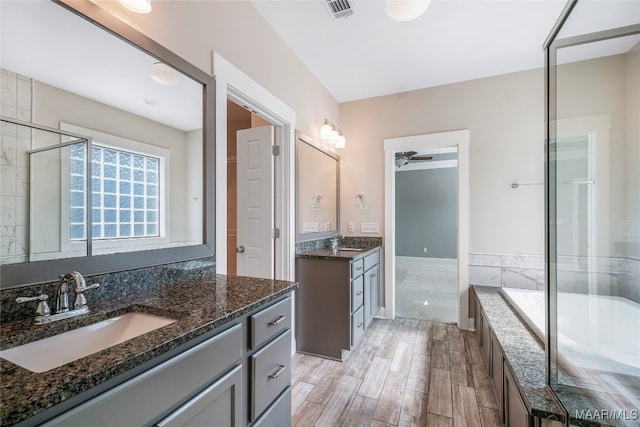 bathroom featuring hardwood / wood-style floors, vanity, and a washtub