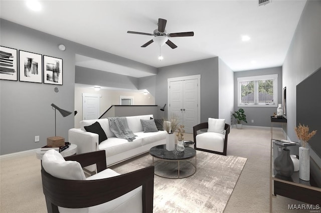 living room featuring ceiling fan and light colored carpet