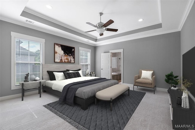 carpeted bedroom featuring connected bathroom, a tray ceiling, ceiling fan, and ornamental molding